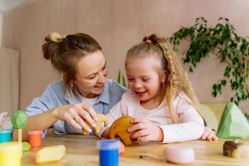 Family child care provider engages with a child in a home-based child care program